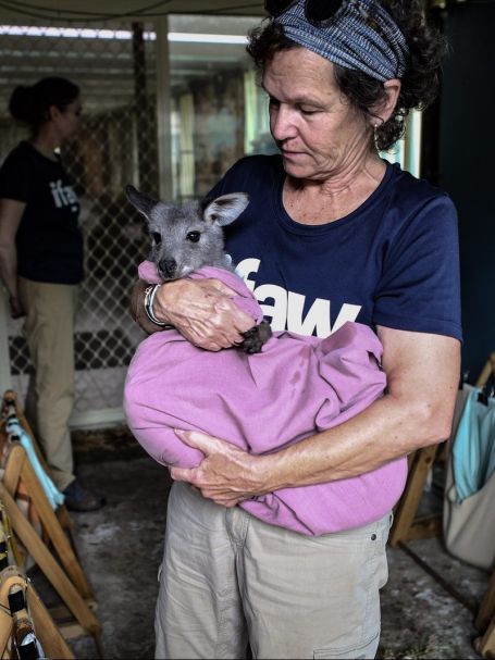 Woman Carrying a Baby Wallaby